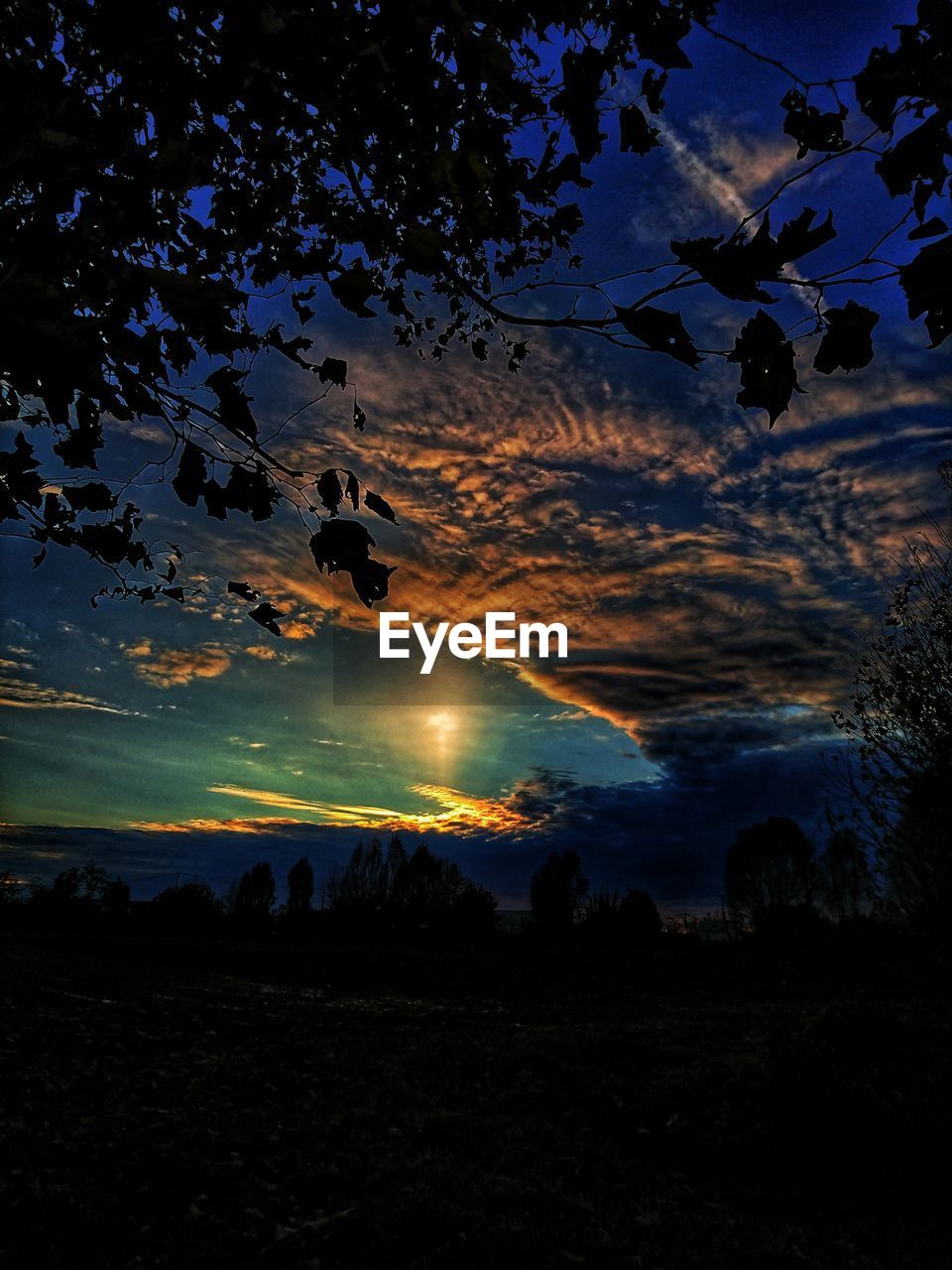 SCENIC VIEW OF SILHOUETTE FIELD AGAINST SKY AT SUNSET