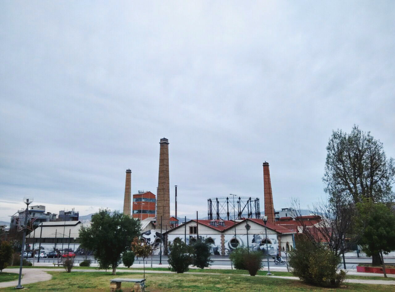 Factory on field against sky