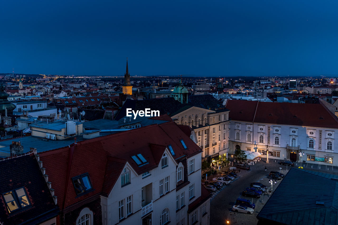 High angle shot of illuminated cityscape against sky at dusk