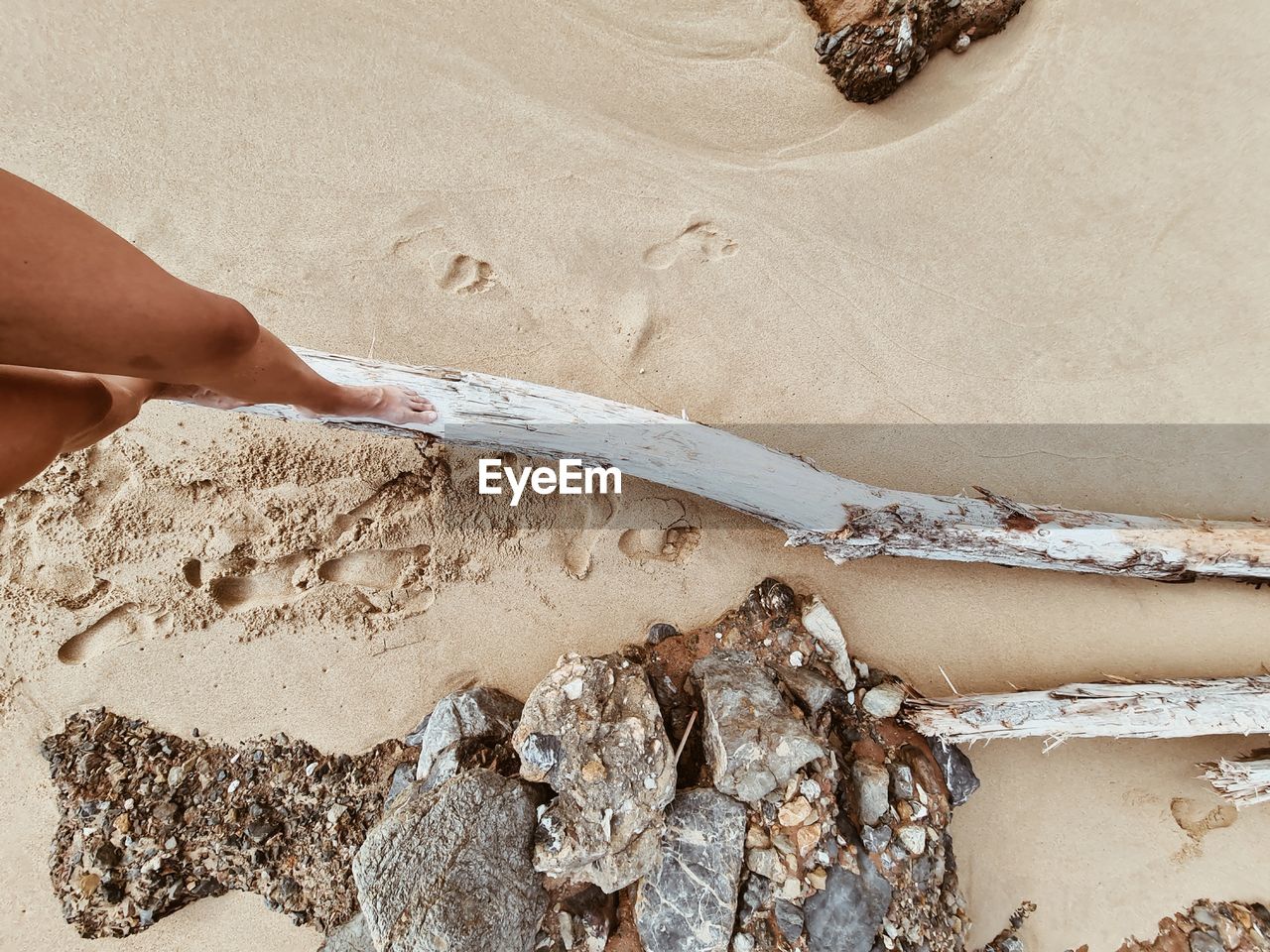 HIGH ANGLE VIEW OF HAND ON SAND