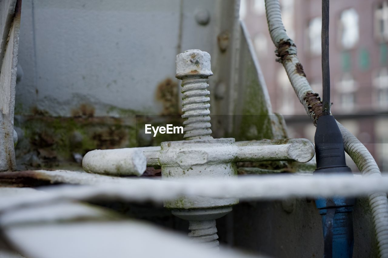 CLOSE-UP OF RUSTY PIPE IN WATER