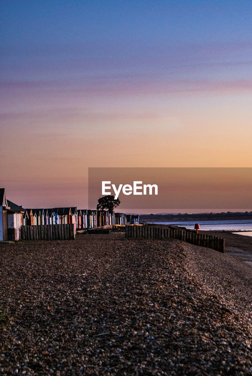 Scenic view of beach against sky during sunrise