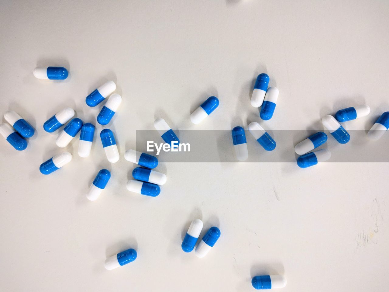 Close-up of scattered capsules over white background