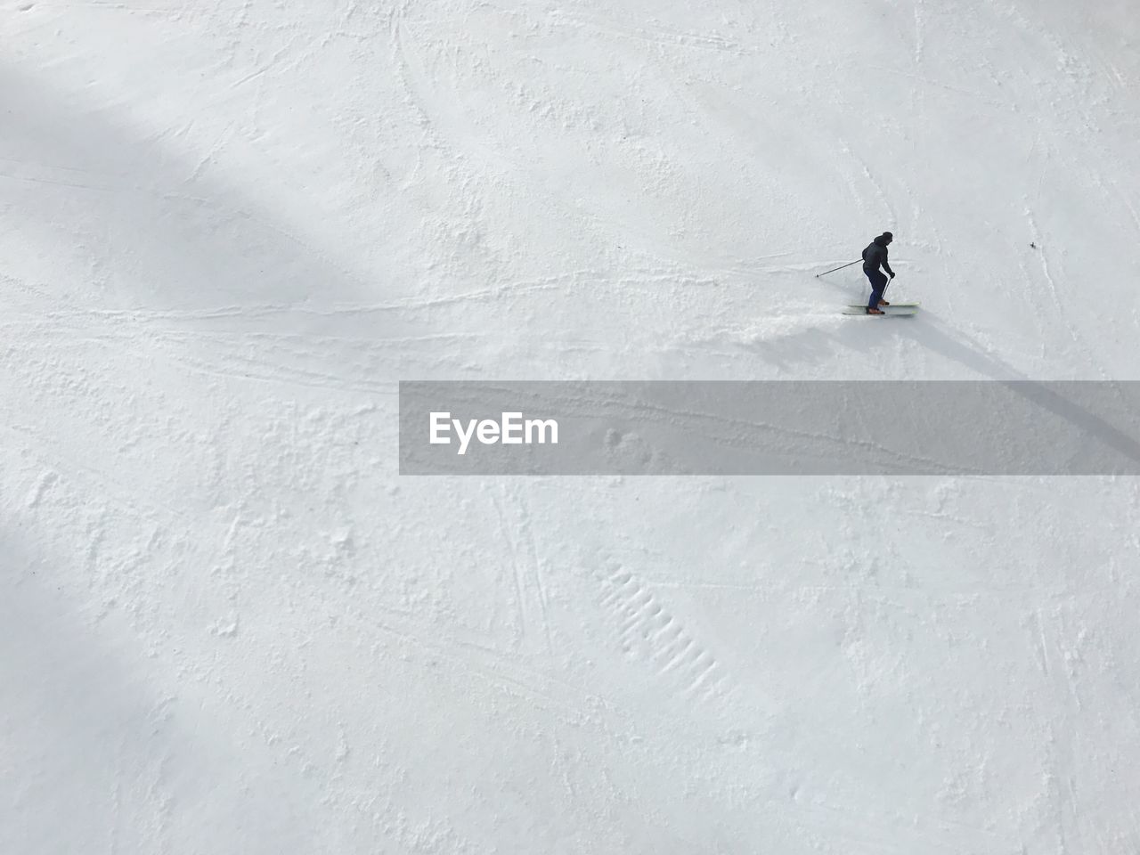 High angle view of person skiing on snow covered field