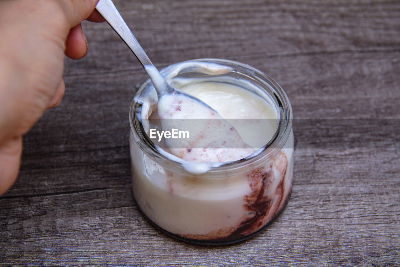 MIDSECTION OF PERSON HOLDING ICE CREAM