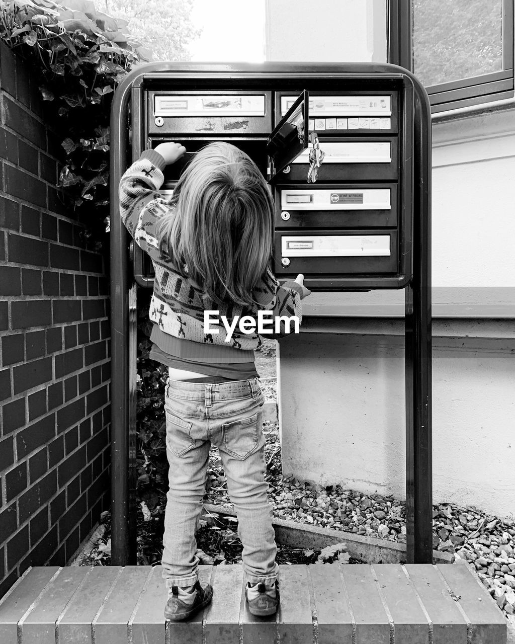 REAR VIEW OF GIRL STANDING IN SHOPPING CART