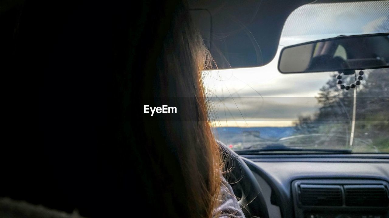 ROAD SEEN THROUGH WINDSHIELD OF CAR