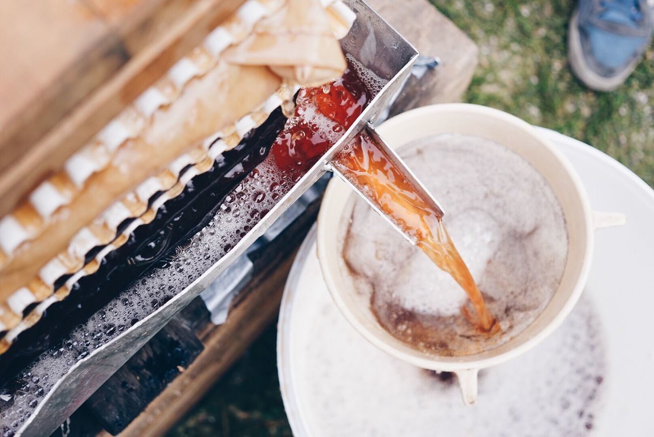 High angle view of apple cider being poured into mug