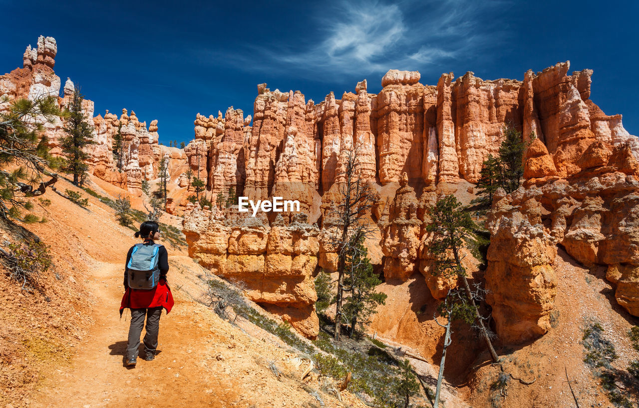 Rear view of female hiker hiking queens garden trail at bryce canyon national park