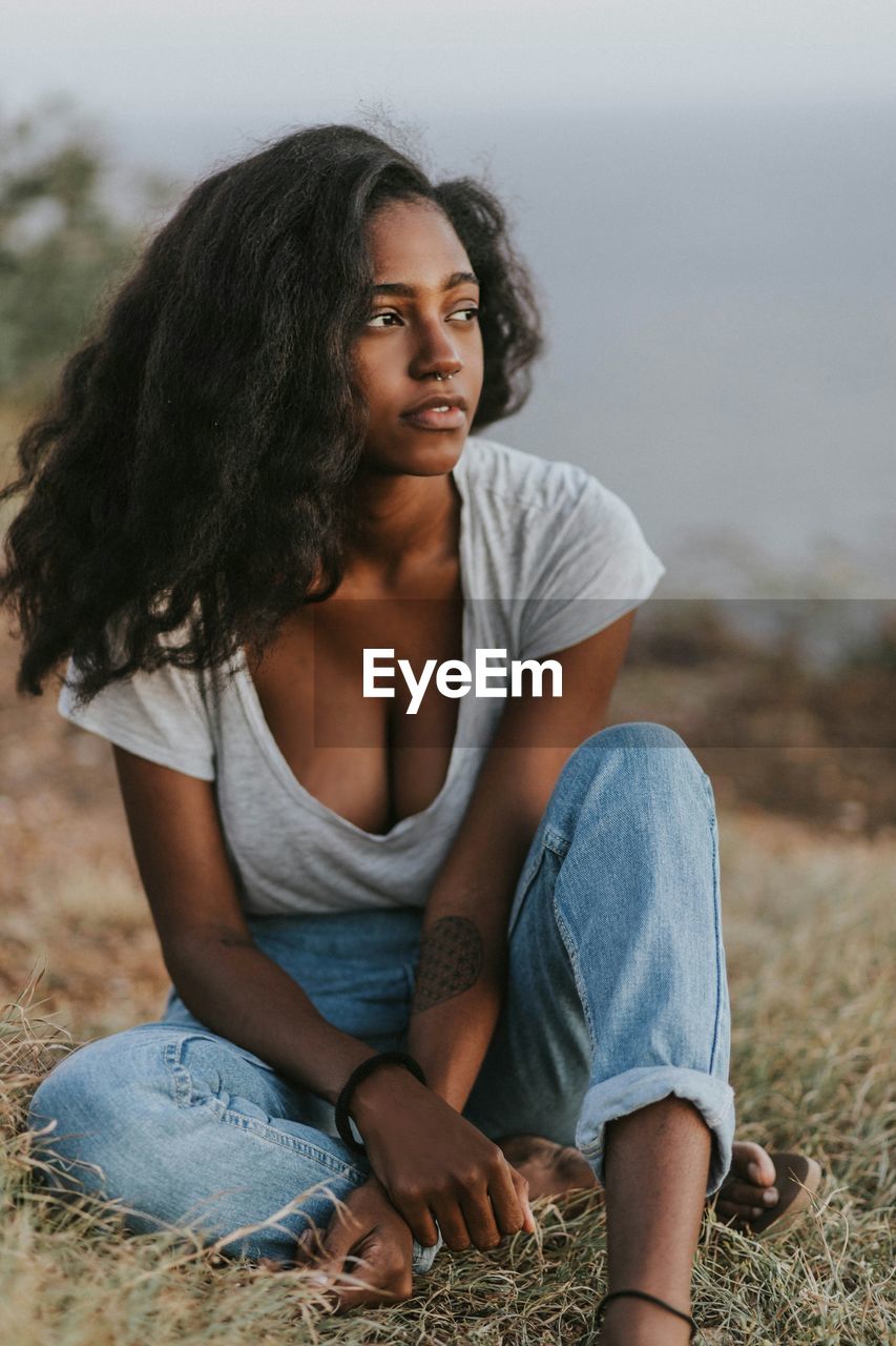 Young woman sitting on field