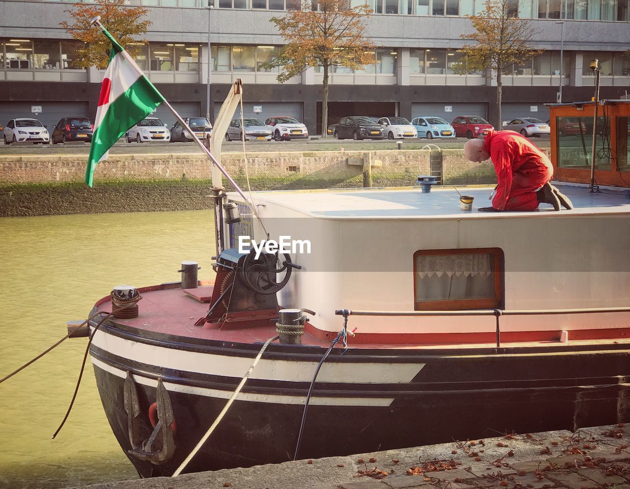 PEOPLE IN BOAT AGAINST BUILDINGS