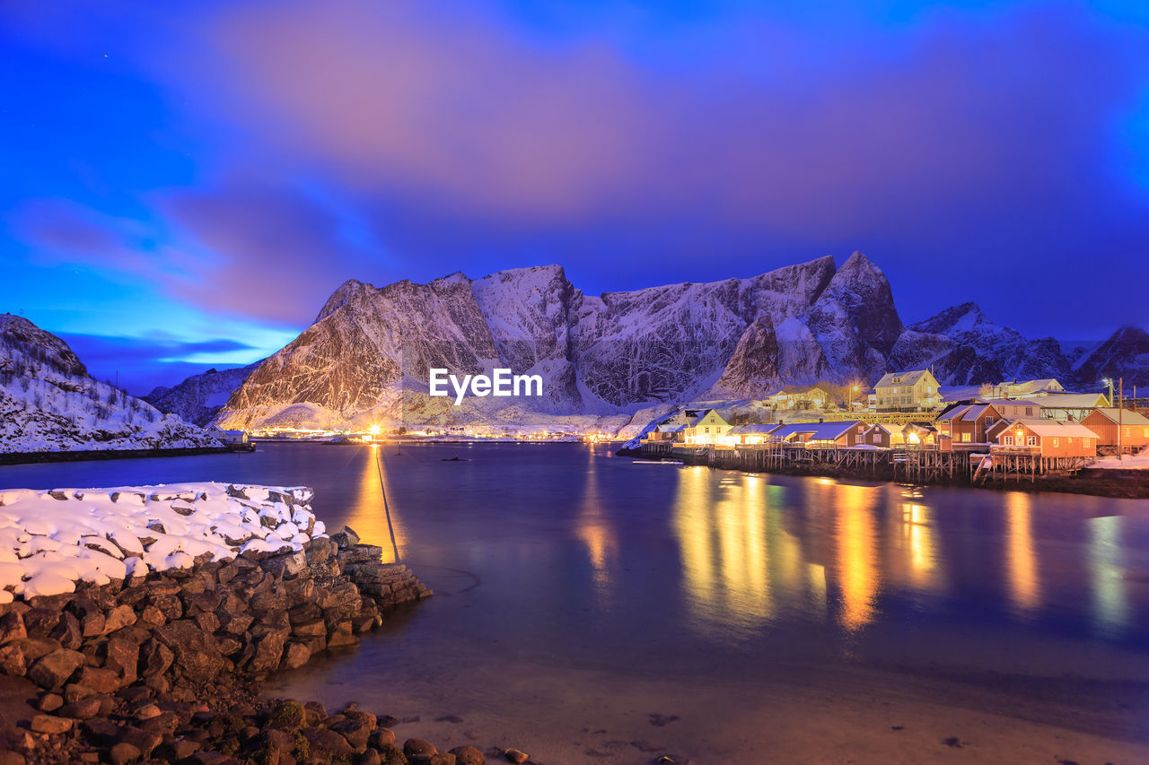 Scenic view of lake and mountains against sky during winter