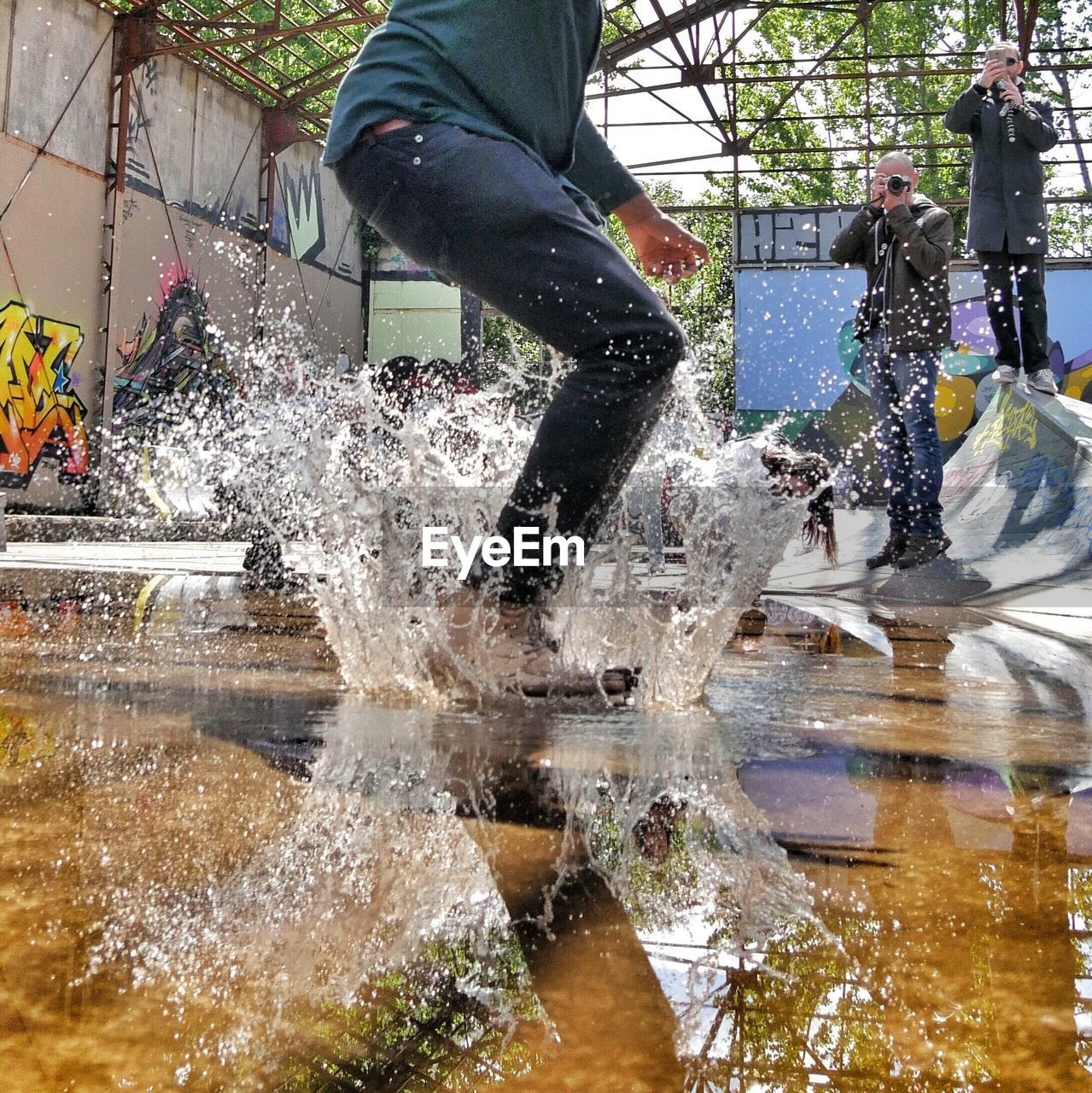 Low section of man jumping in water