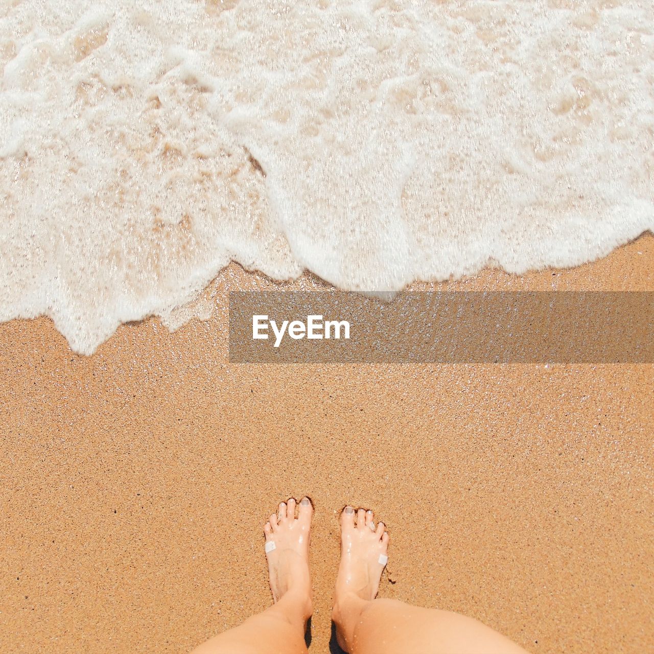 Low section of woman at beach