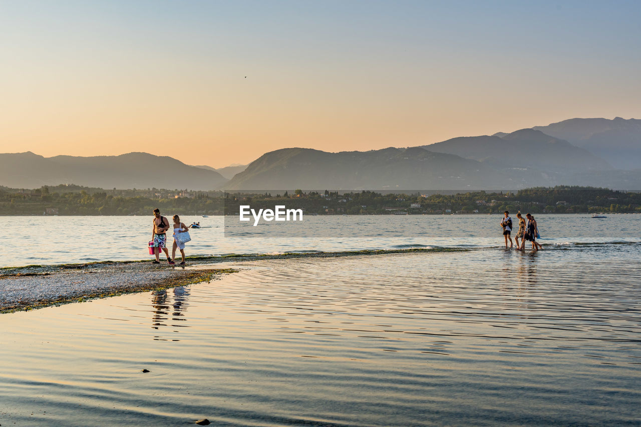 SCENIC VIEW OF SEA WITH MOUNTAIN IN BACKGROUND