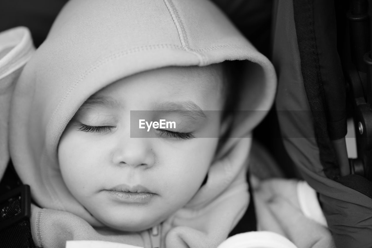 Close-up of cute baby sleeping in stroller