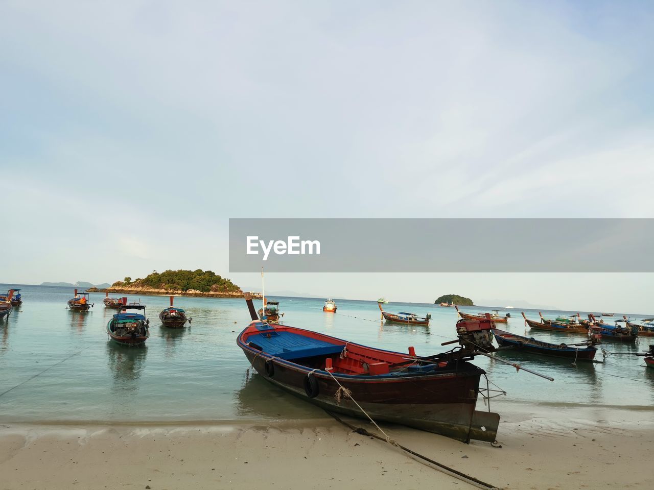 water, nautical vessel, transportation, sky, sea, mode of transportation, beach, shore, land, nature, moored, coast, boat, vehicle, bay, travel, tranquility, cloud, ocean, sand, body of water, vacation, day, scenics - nature, travel destinations, beauty in nature, boating, outdoors, watercraft, tranquil scene, no people, reflection, ship, tourism, long-tail boat, fishing, fishing boat, holiday, trip, fishing industry, idyllic