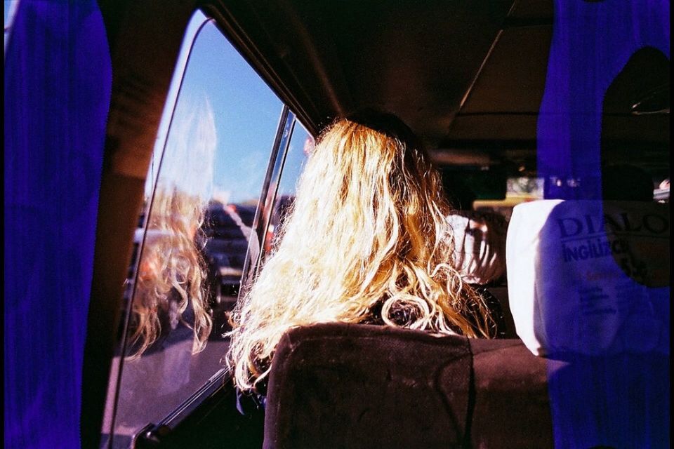 Close-up of woman looking through window