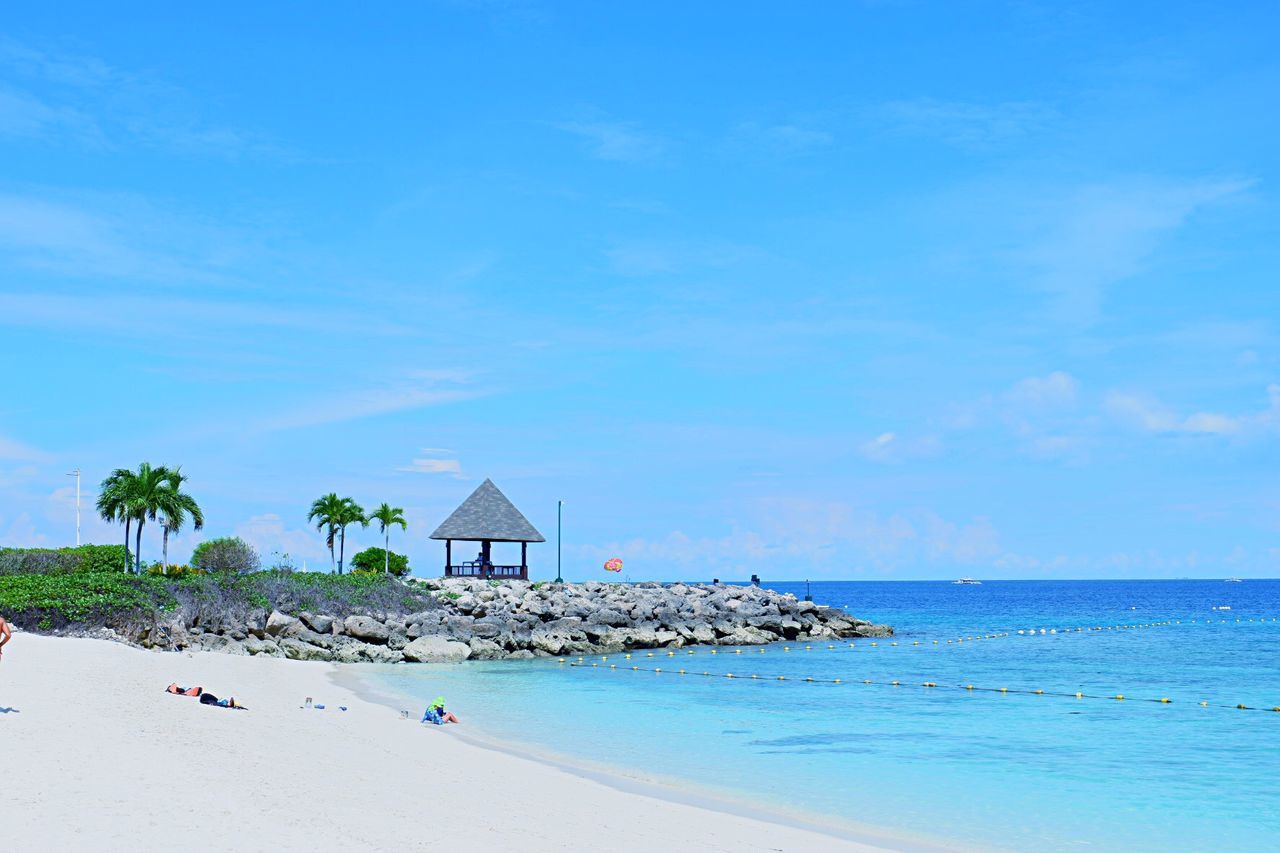 Scenic view of beach against blue sky