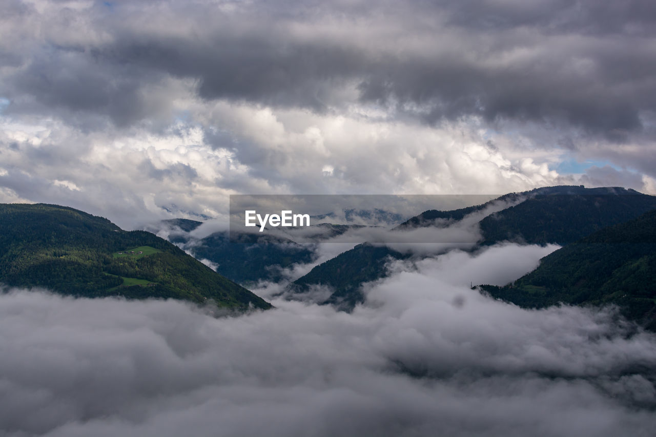 Scenic view of mountains against cloudy sky