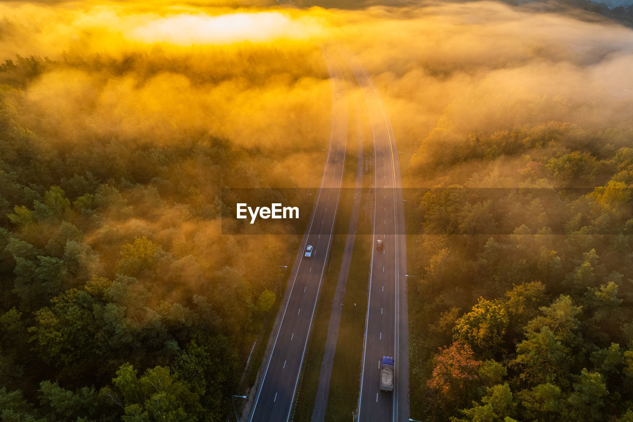Aerial autumn fall sunrise view of foggy forest in vilnius, lithuania