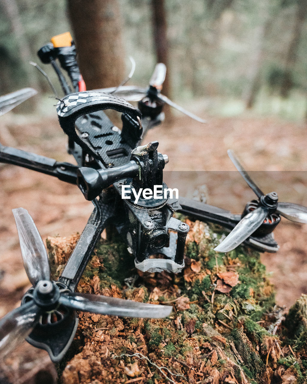 High angle view of broken drone in the forest