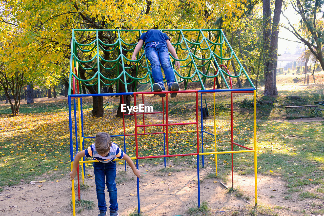 Brother and sister playing at playground