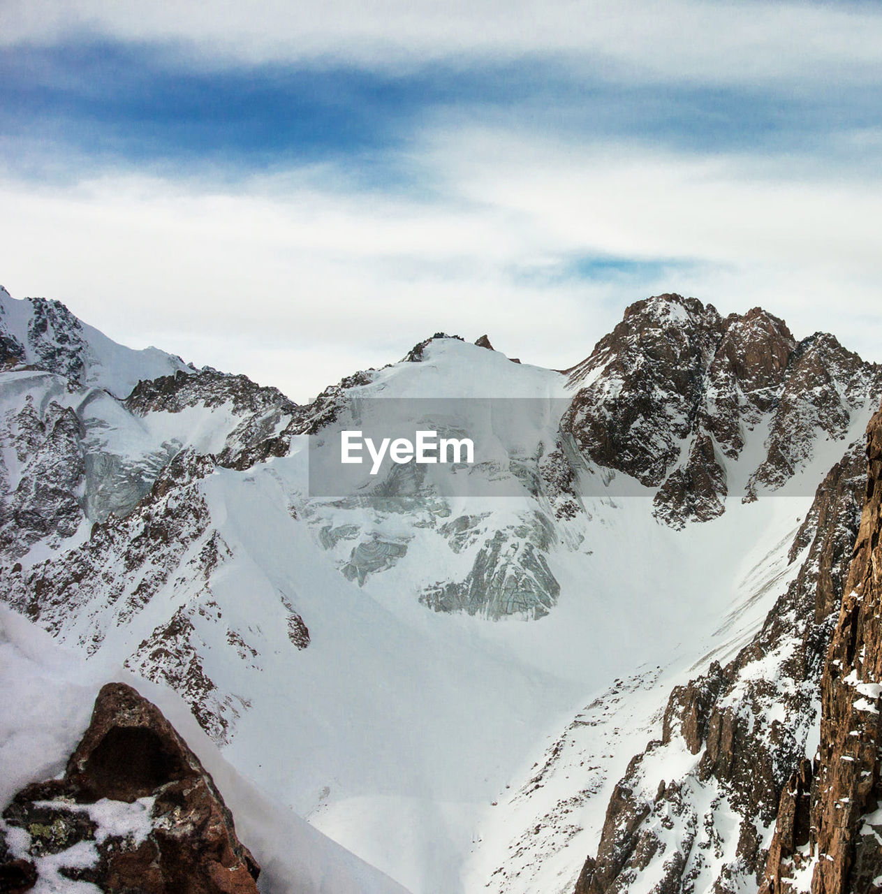 Scenic view of snow covered mountains against sky