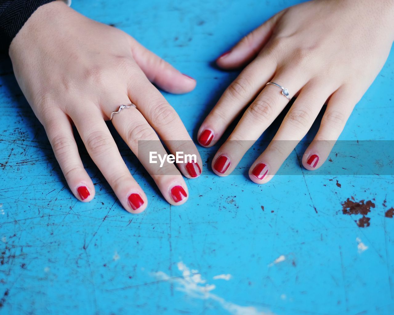 Cropped image of hands with red nail polish
