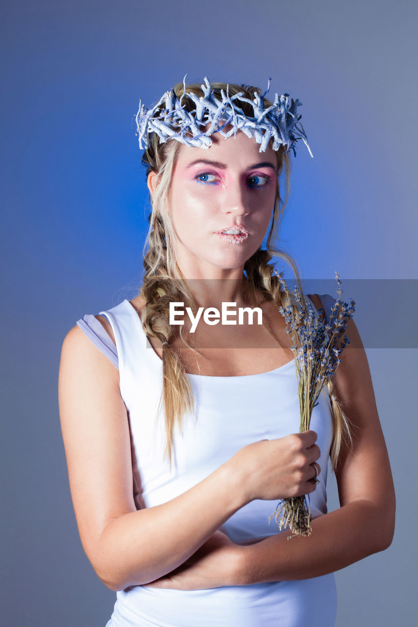 Portrait of a beautiful young woman over blue background