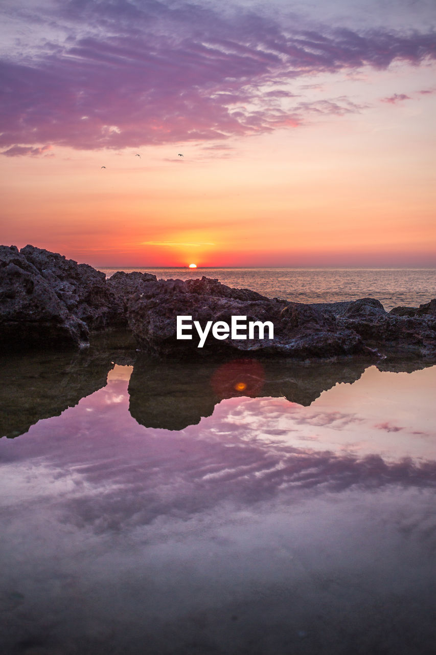 Scenic view of sea against sky during sunset