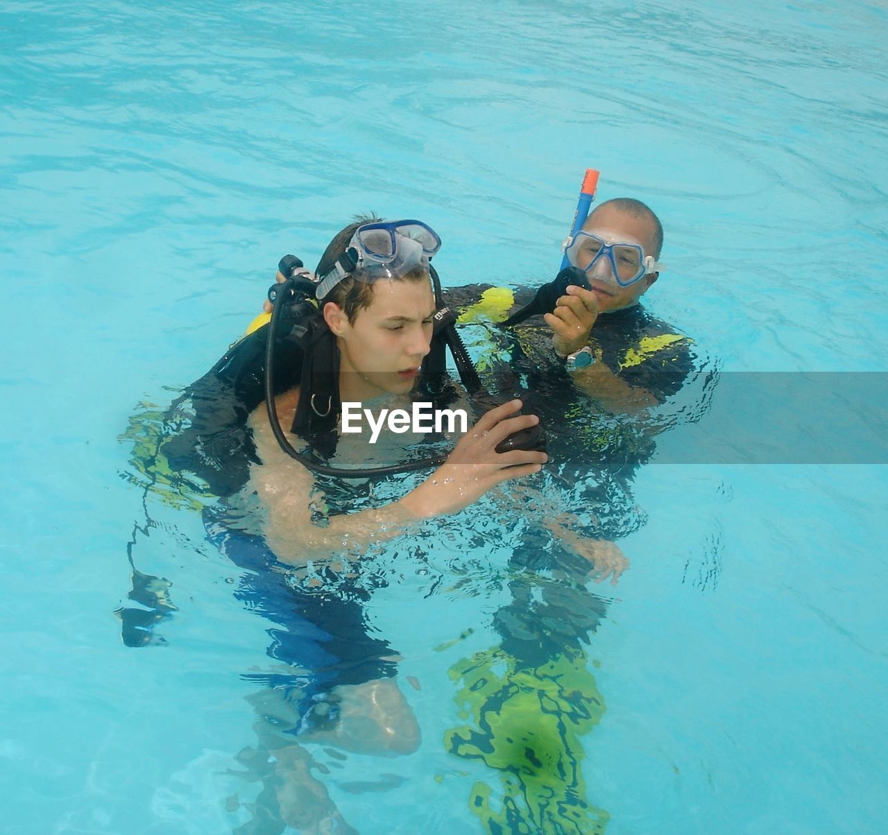 Father and son swimming in pool