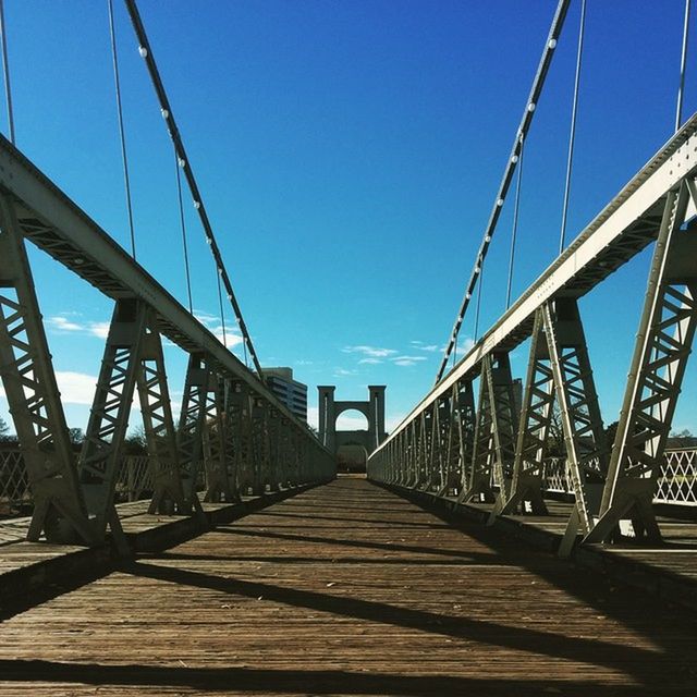 SUSPENSION BRIDGE AGAINST CLEAR SKY