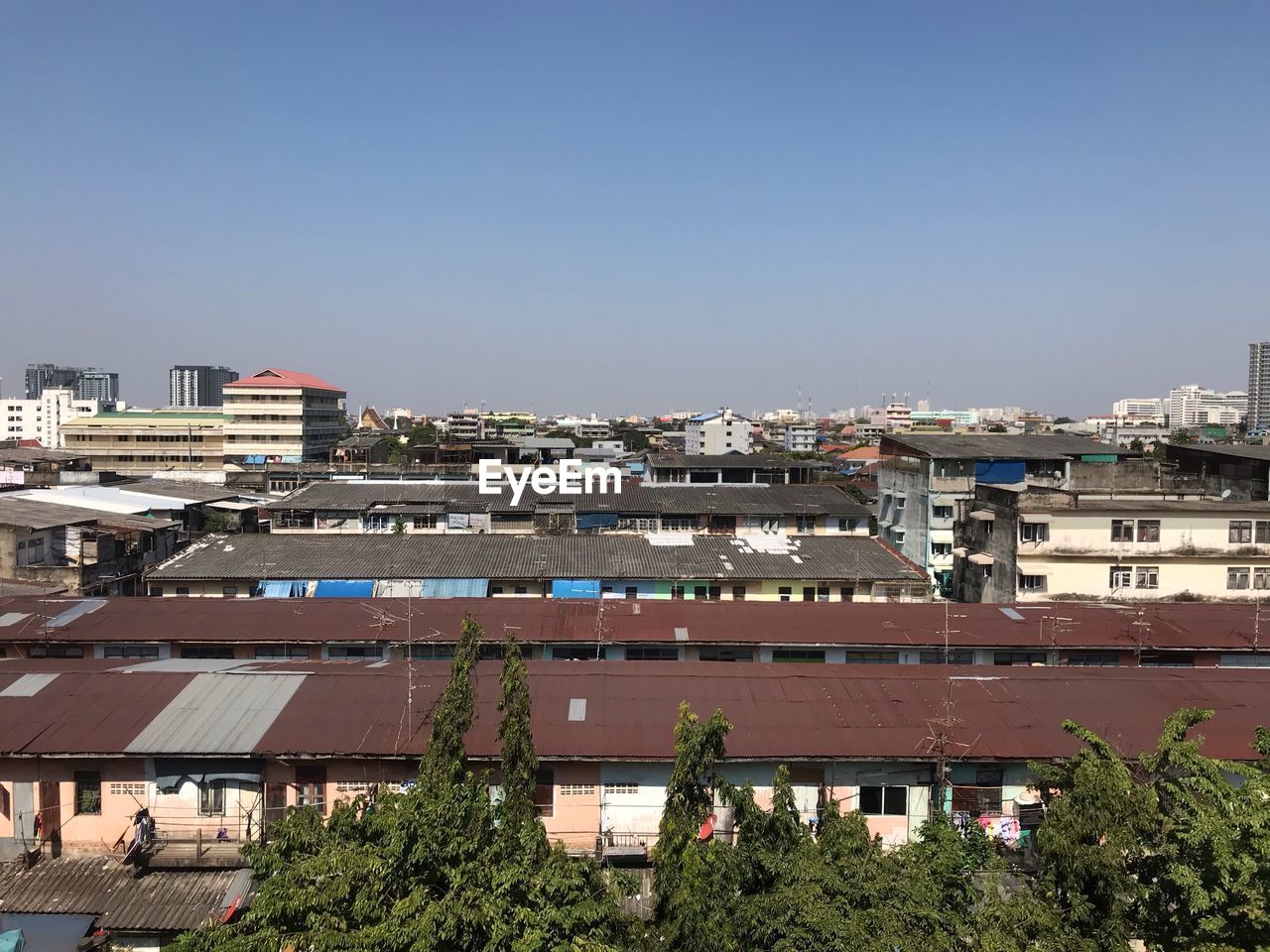 High angle view of buildings against clear blue sky