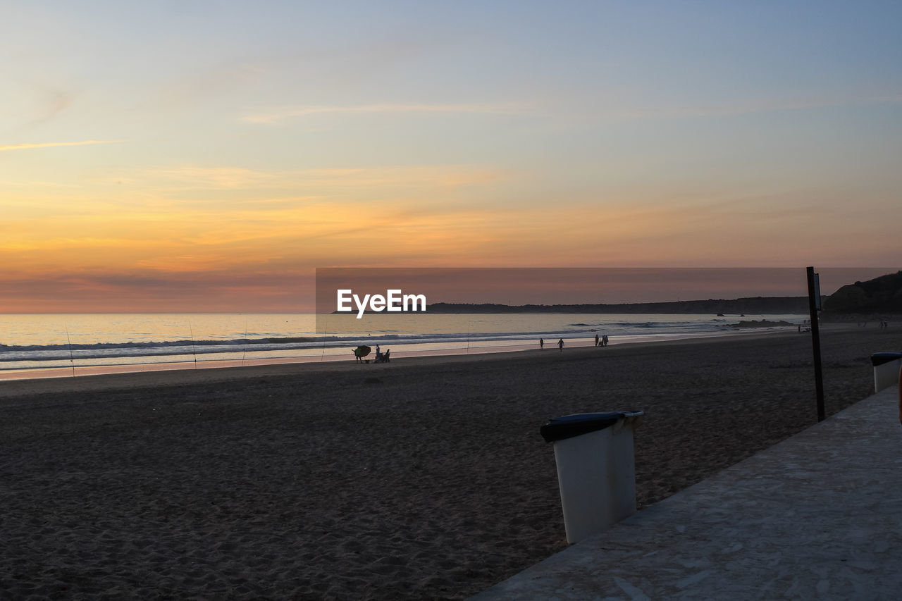 Scenic view of beach against sky during sunset