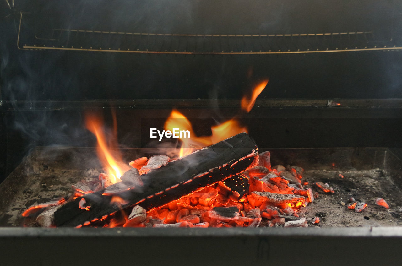 CLOSE-UP OF BURNING FIRE IN THE BACKGROUND