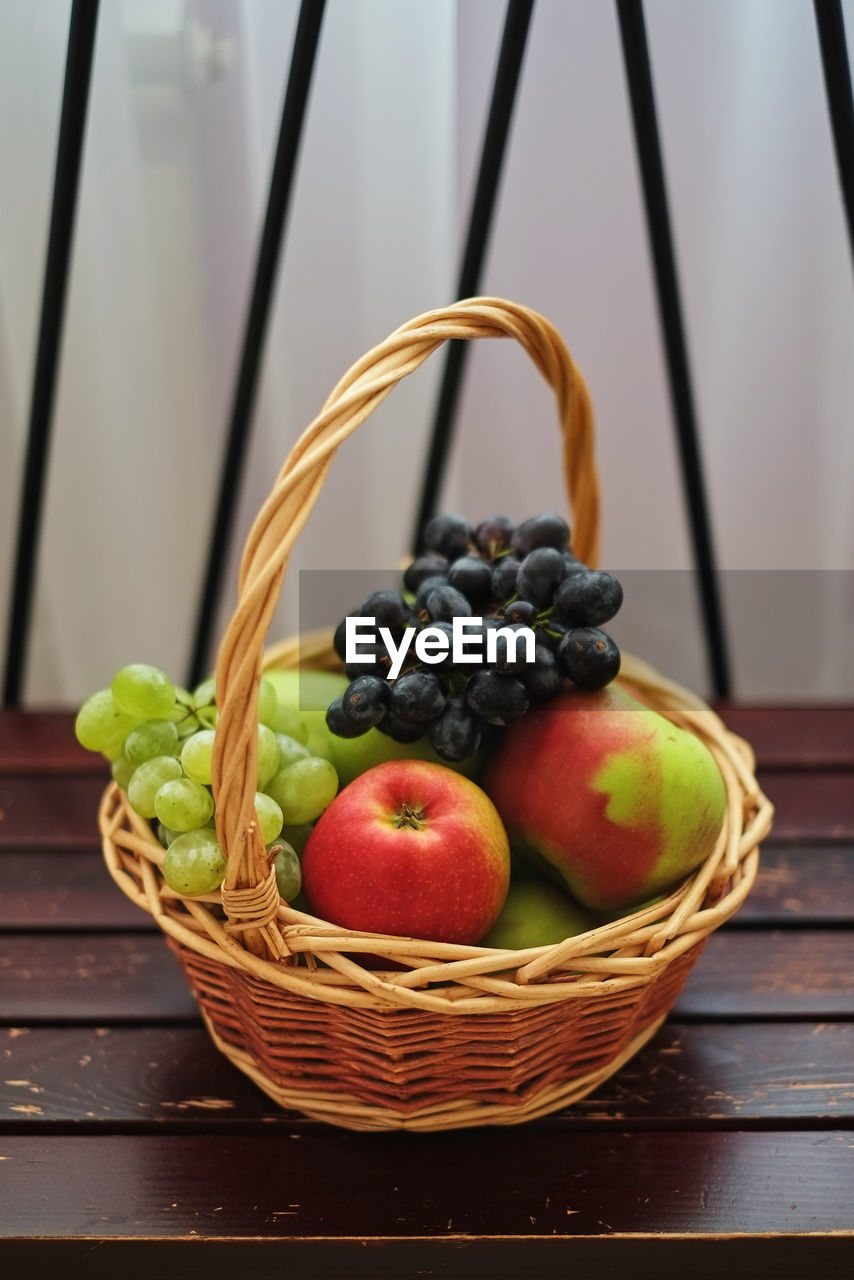 CLOSE-UP OF FRESH FRUITS IN BASKET