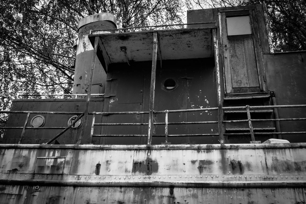 LOW ANGLE VIEW OF RUSTY BUILDING