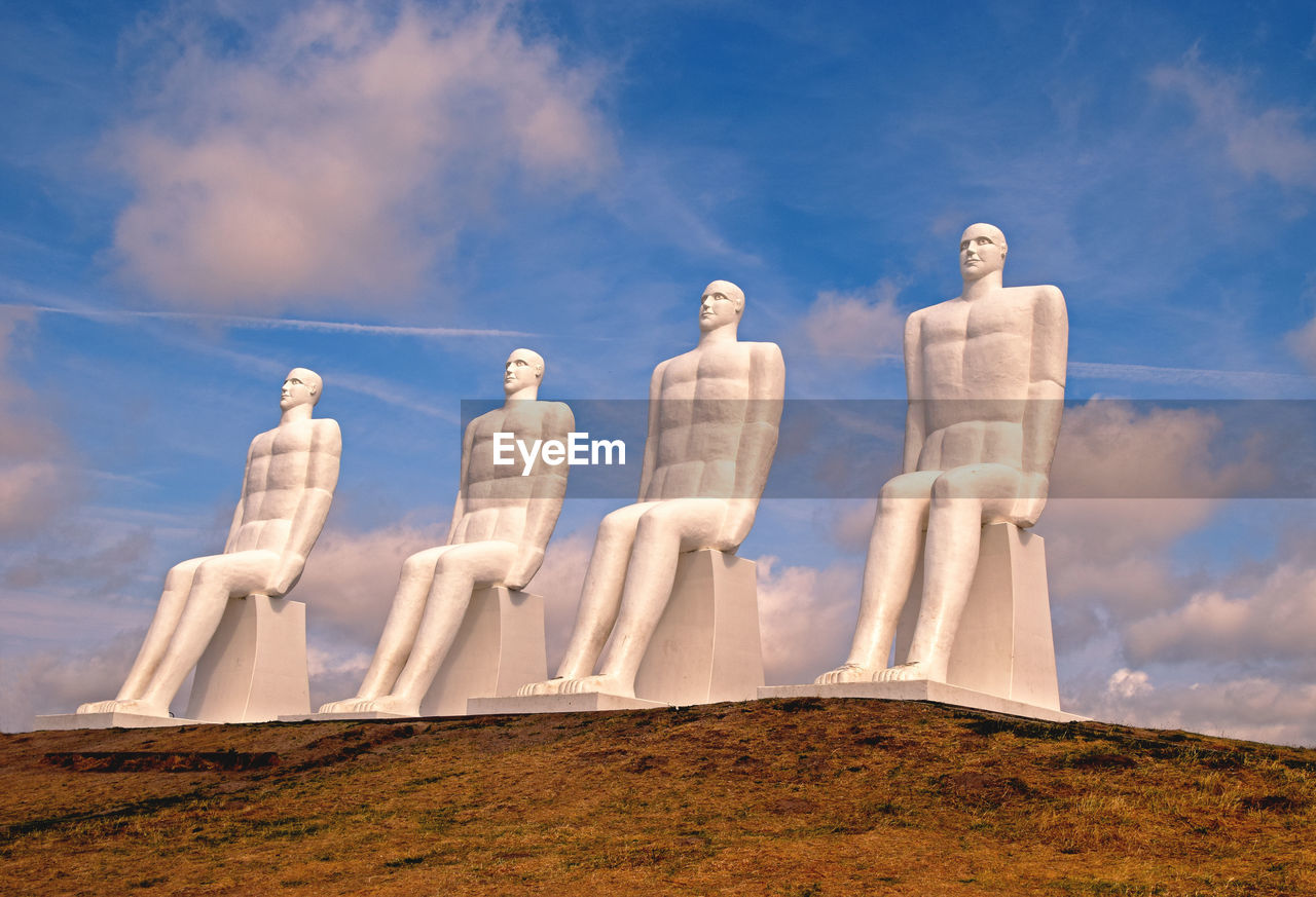 LOW ANGLE VIEW OF STATUES ON LAND AGAINST SKY