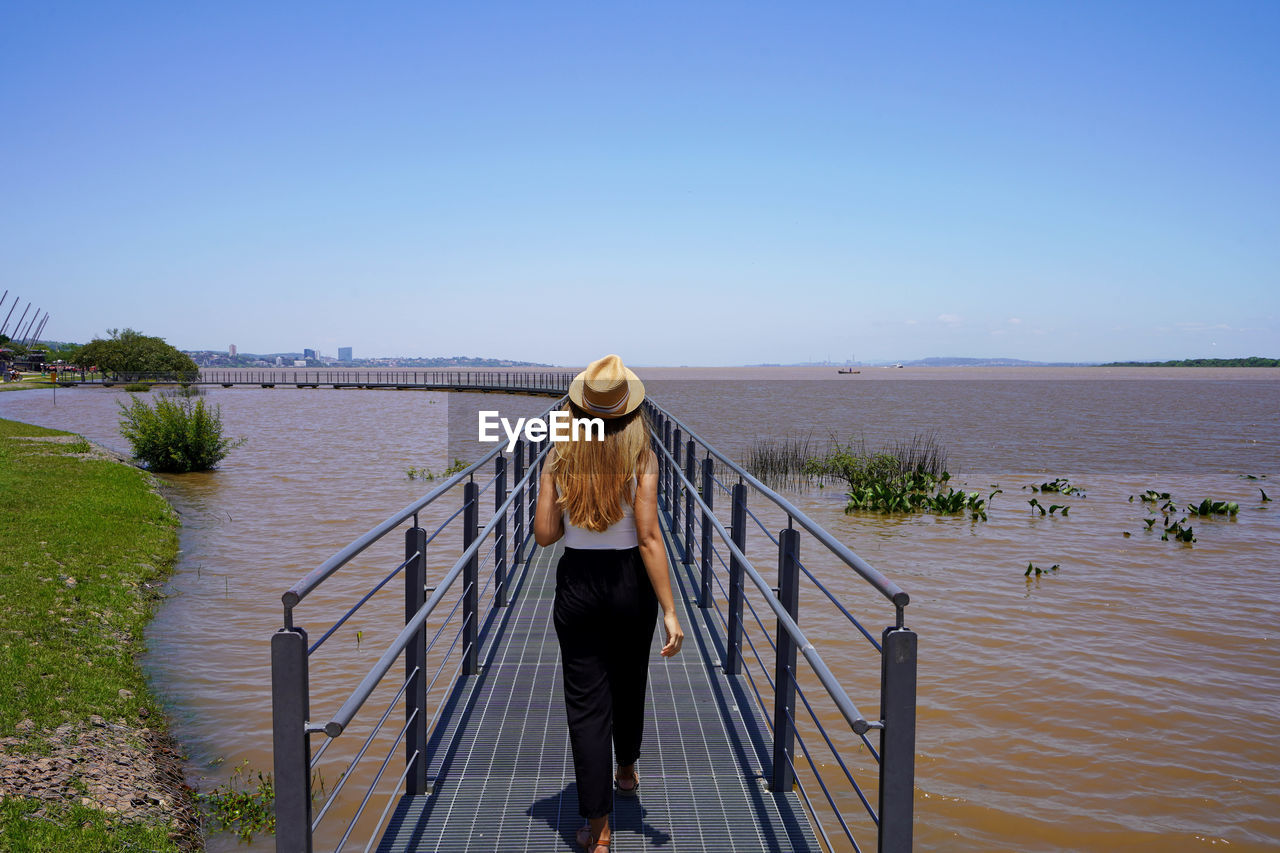 Girl walks on attraction in orla do guaiba, porto alegre, rio grande do sul, brazil