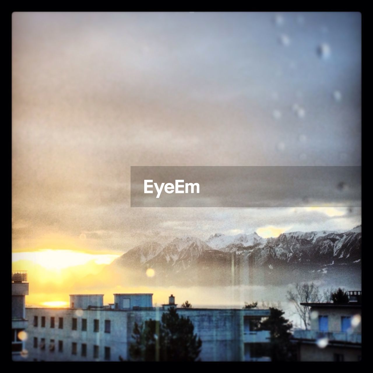 View of buildings against snow mountains