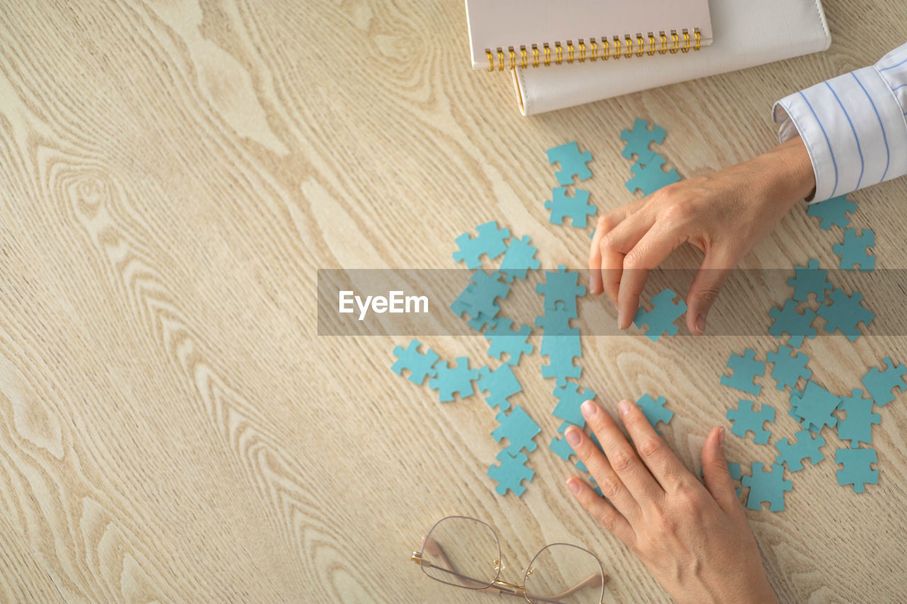 cropped hand of person holding jigsaw piece