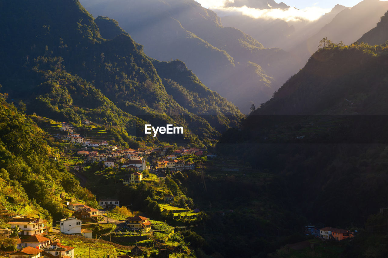 high angle view of trees and mountains against sky