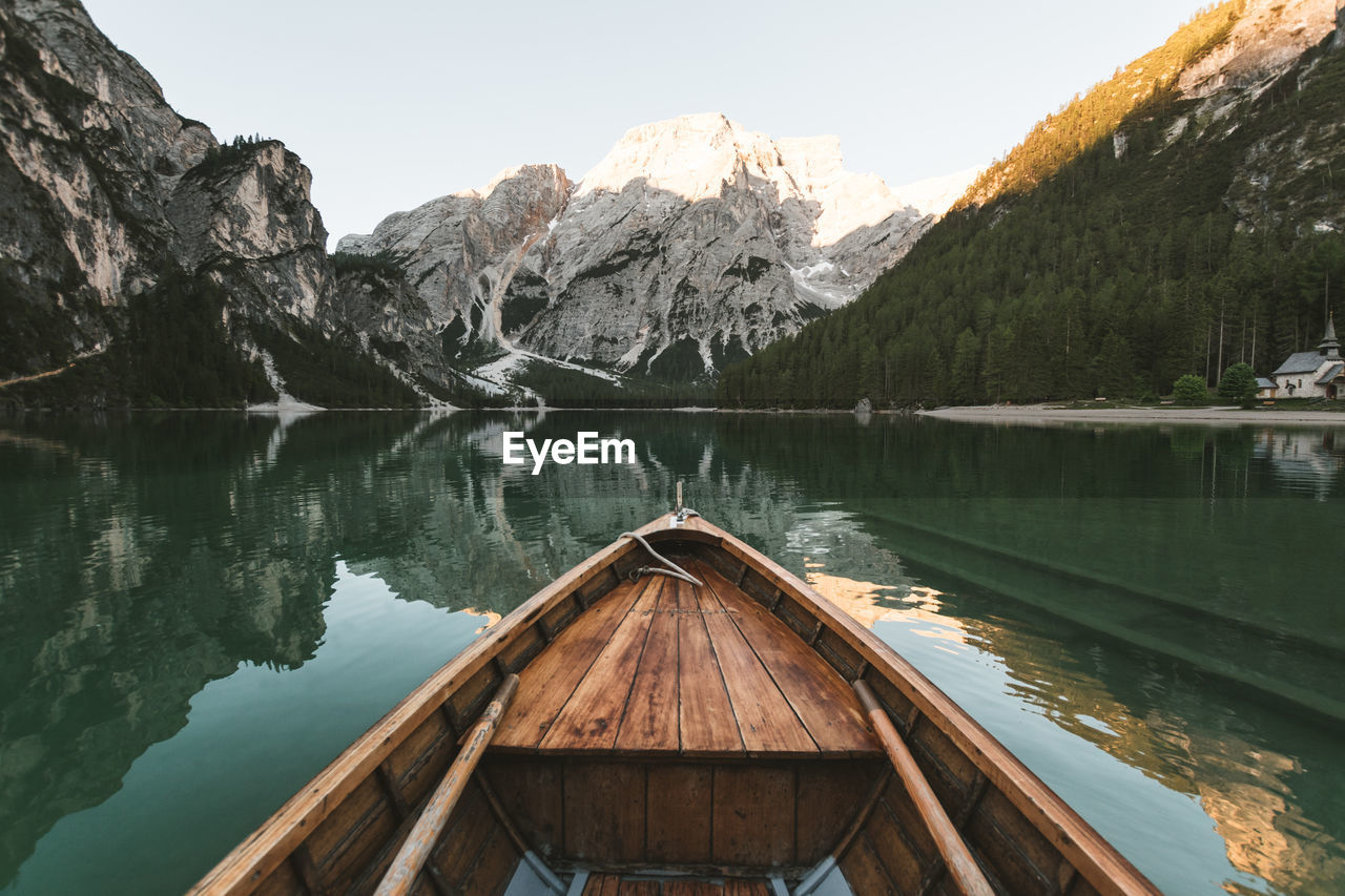 Scenic view of lake by snowcapped mountains against sky