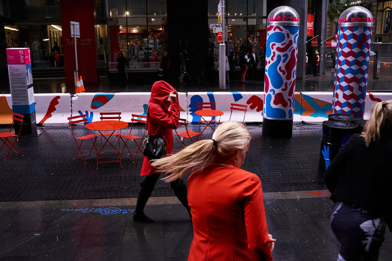 Women walking on footpath in city