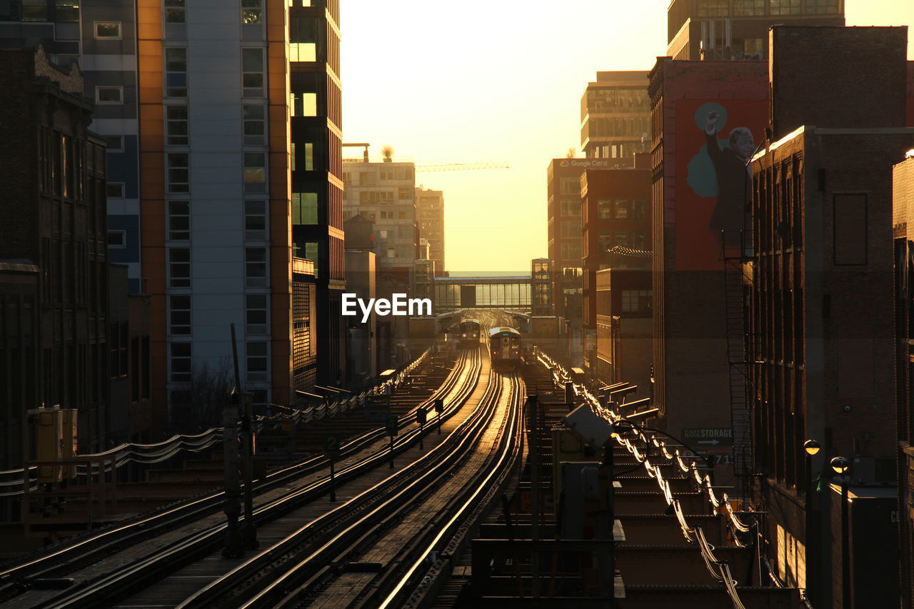 HIGH ANGLE VIEW OF RAILROAD TRACKS AND BUILDINGS IN CITY