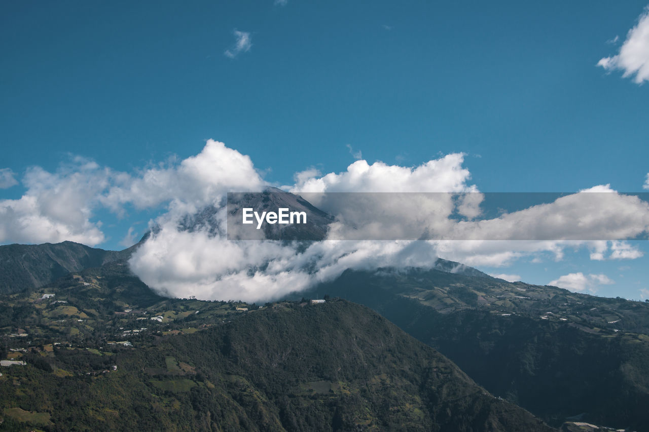 Scenic view of mountains against cloudy sky