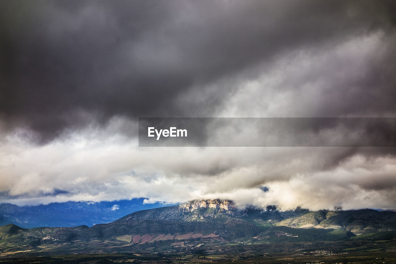 Big clouds and a mountain at the background