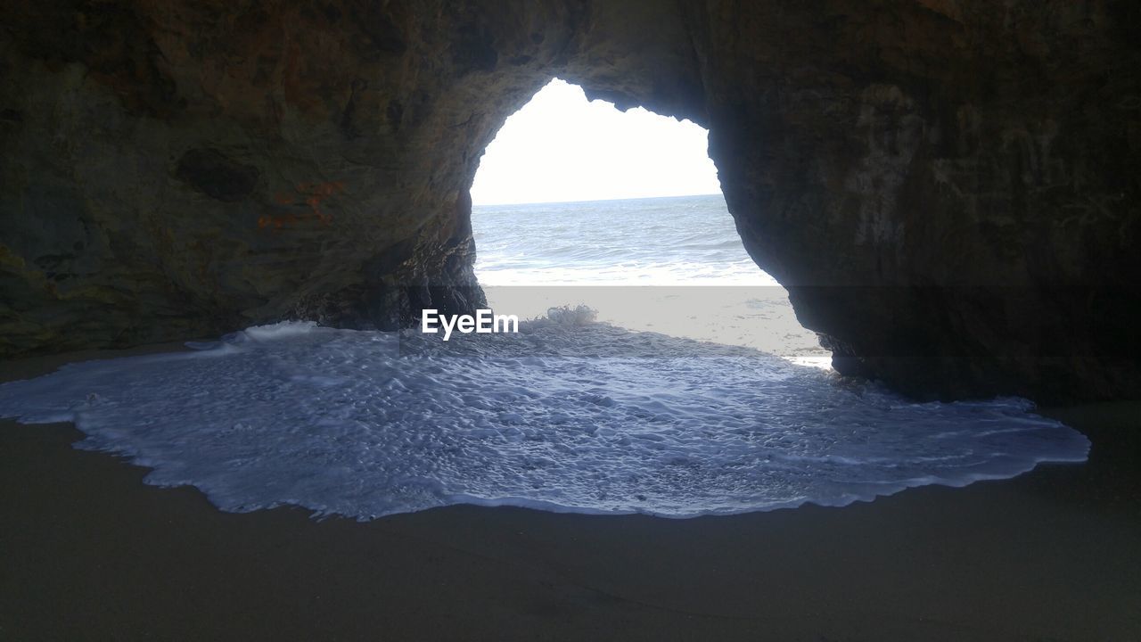 SCENIC VIEW OF SEA THROUGH CAVE