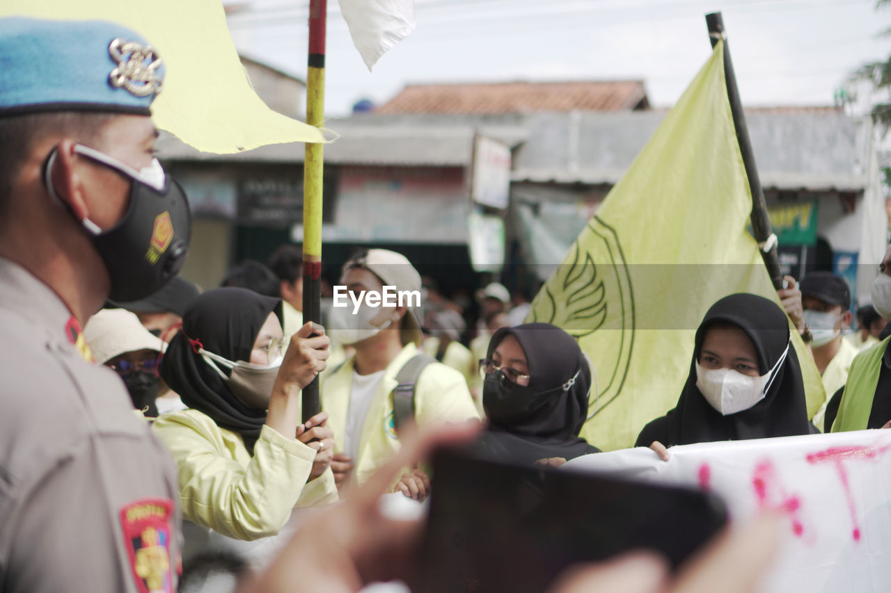 group of people, men, crowd, adult, day, event, women, large group of people, selective focus, protest, togetherness, young adult, outdoors, festival, candid, celebration, person, education